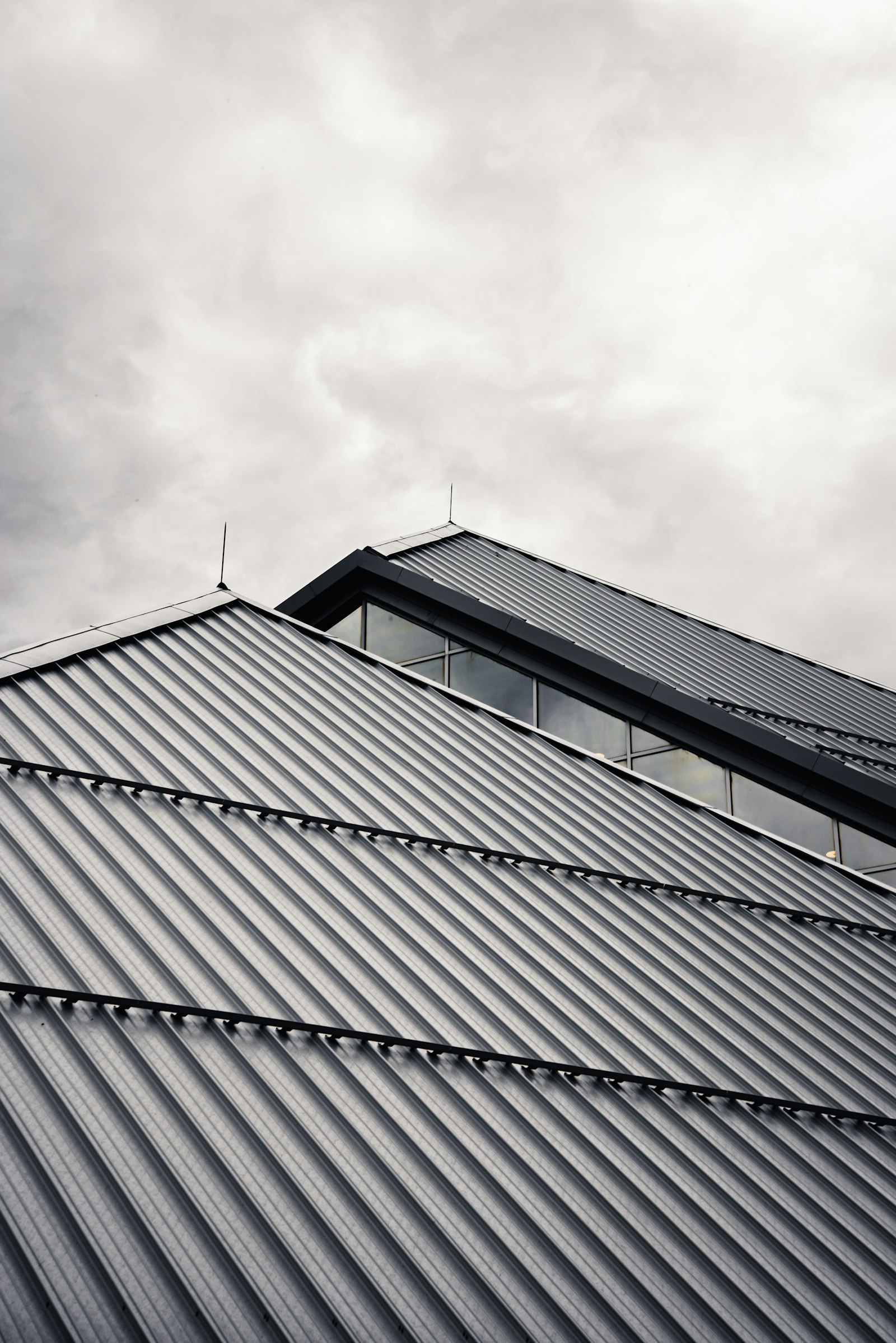 Standing seam metal roof against a moody sky