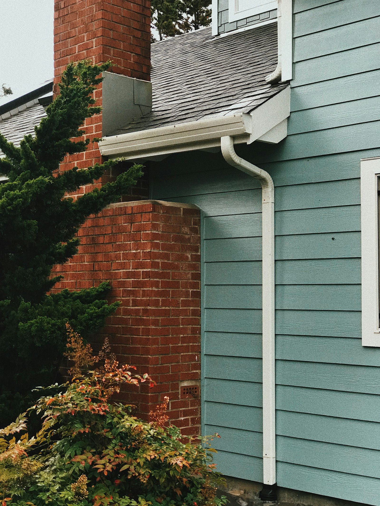 Clean roof edge with new gutters and downspout