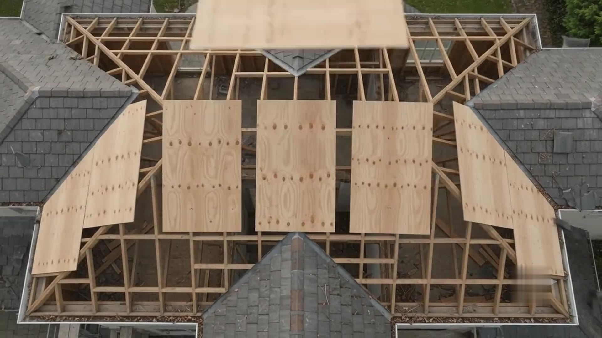 Roof stripped to the framing with new plywood decking going on