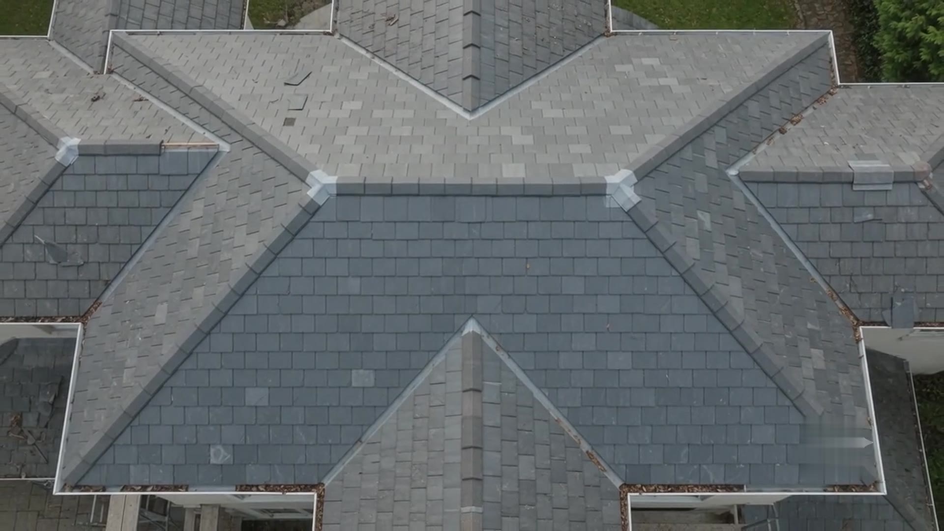 Brand new uniform slate-grey tile roof from above
