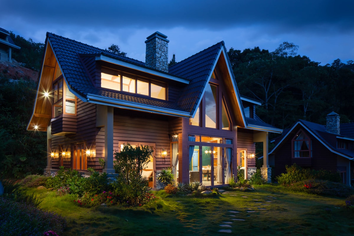 Timber chalet lodge glowing at dusk